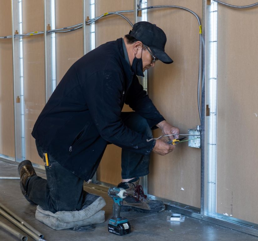 A Philco employee installing outlets in a commercial clients new build